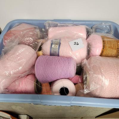 26 cones of yarn in pink