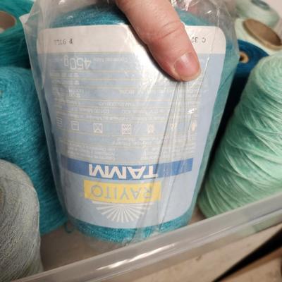16 cones of yarn in aqua