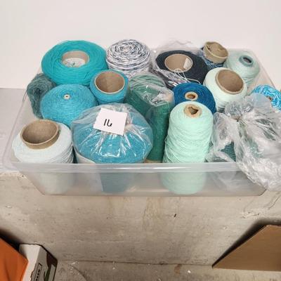 16 cones of yarn in aqua
