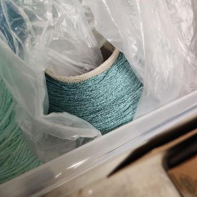 16 cones of yarn in aqua