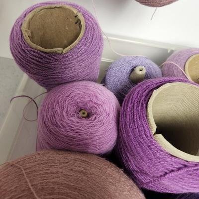 16 cones of yarn in purple