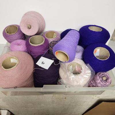 16 cones of yarn in purple
