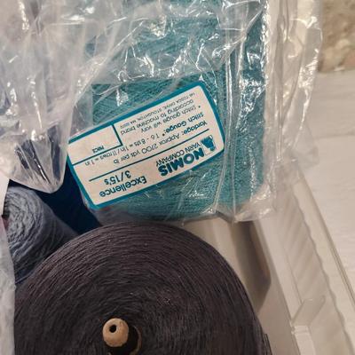 16 cones of yarn in blue