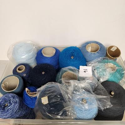 16 cones of yarn in blue