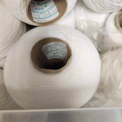 17 cones of yarn in white