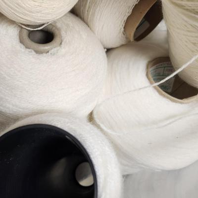 17 cones of yarn in white