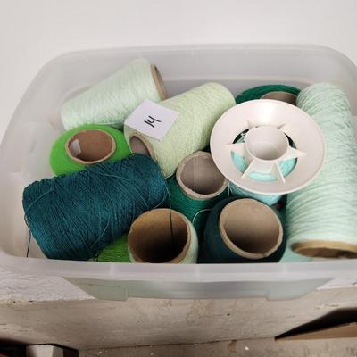 14 cones of yarn in green