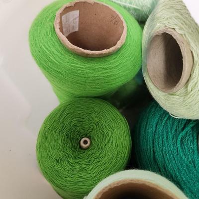 14 cones of yarn in green