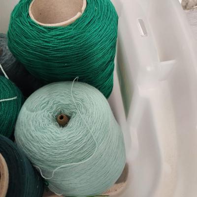 14 cones of yarn in green
