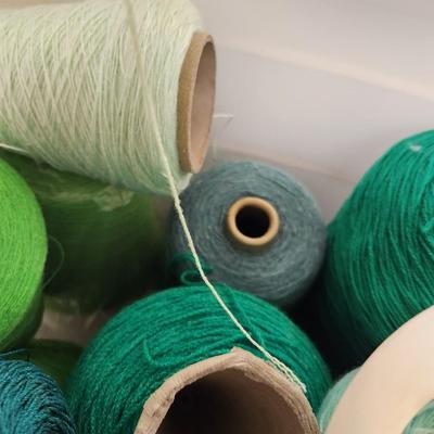 14 cones of yarn in green