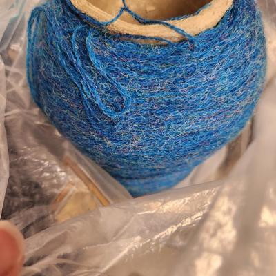 16 cones of yarn in blue