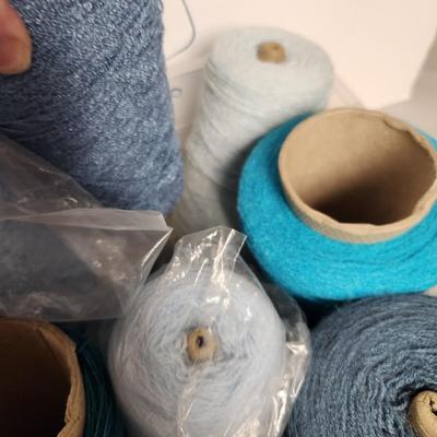 16 cones of yarn in blue