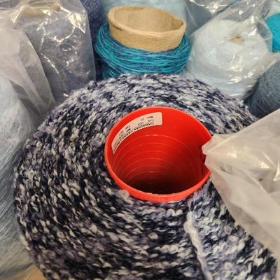 16 cones of yarn in blue