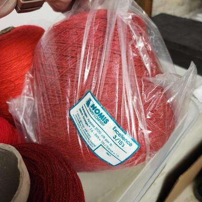 13 cones of yarn in red