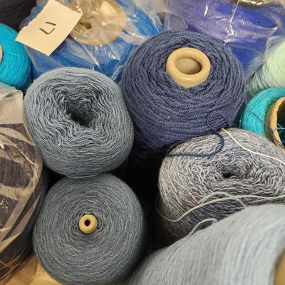 17 cones of yarn in blue