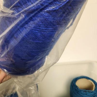 17 cones of yarn in blue