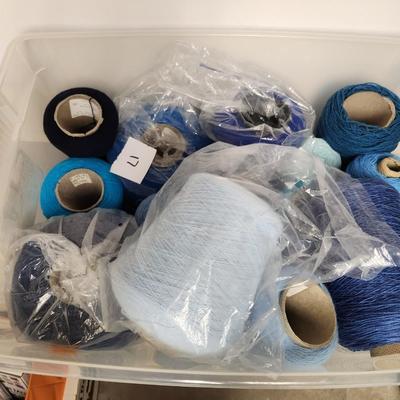 17 cones of yarn in blue