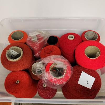 12 cones of yarn in red