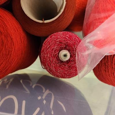 12 cones of yarn in red
