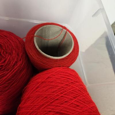 12 cones of yarn in red