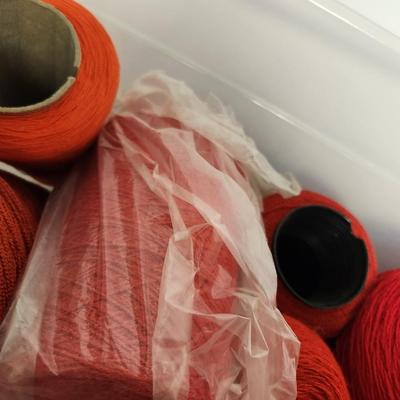 12 cones of yarn in red