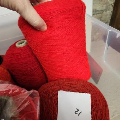 12 cones of yarn in red