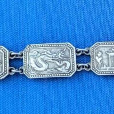 Antique silver link bracelet with different scenes or characters on each link