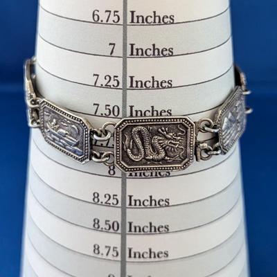 Antique silver link bracelet with different scenes or characters on each link