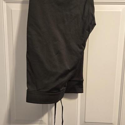 Green Puffer Vest and Dark Green Athletic Pants