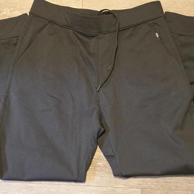 Green Puffer Vest and Dark Green Athletic Pants