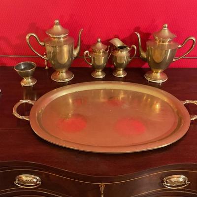 Brass tea set with handled tray, has two tea pots, sugar with cover, creamer, waist bowl