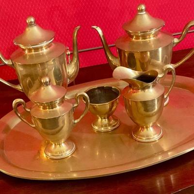 Brass tea set with handled tray, has two tea pots, sugar with cover, creamer, waist bowl