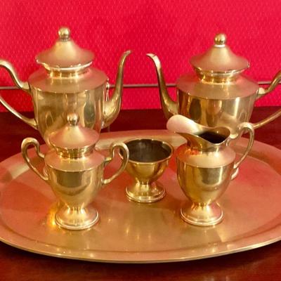 Brass tea set with handled tray, has two tea pots, sugar with cover, creamer, waist bowl