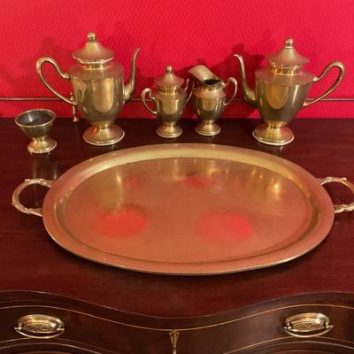 Brass tea set with handled tray, has two tea pots, sugar with cover, creamer, waist bowl