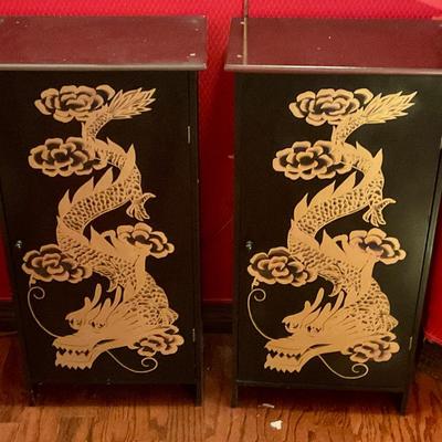 2 black cabinets with gold dragons, have shelves for storage