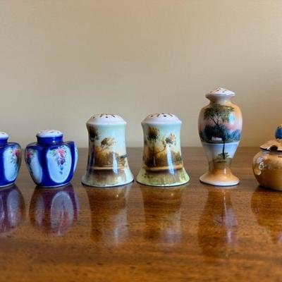 A Collection of Salt & Pepper Shakers with Sugar Trinket