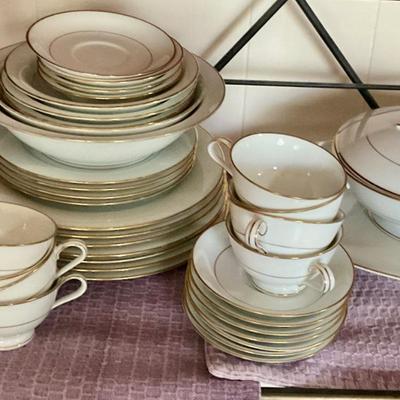 Large set of white dishes with gold trim