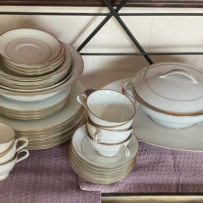 Large set of white dishes with gold trim