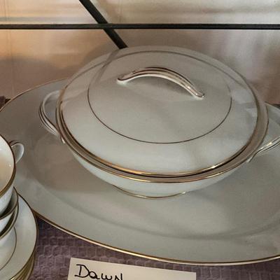 Large set of white dishes with gold trim