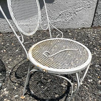 Lot# 190 Round Patio Glass Top Table with a Single White Wrought Iron Chair