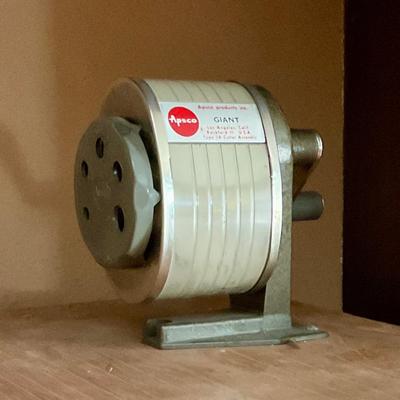 Vintage pencil sharpener mounted on wood block