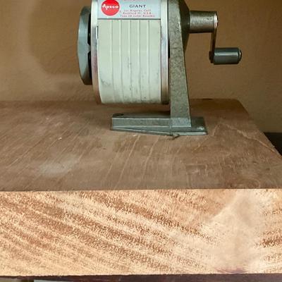 Vintage pencil sharpener mounted on wood block