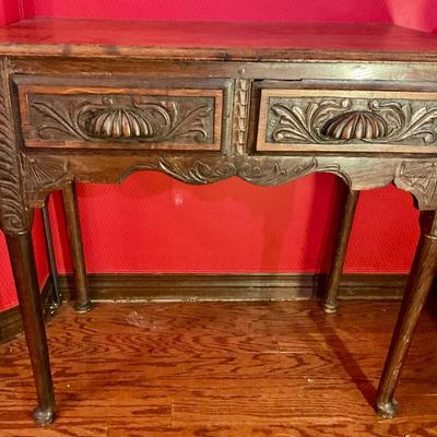 2 drawer antiqued pegged table with carved front and shell drawer pulls