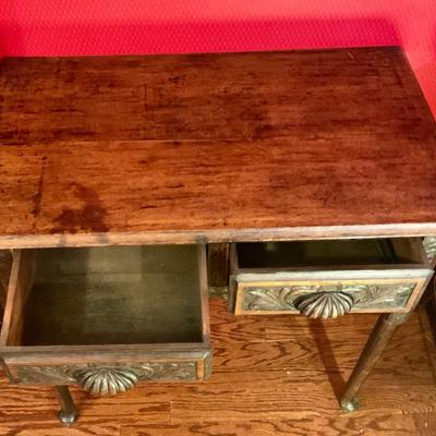 2 drawer antiqued pegged table with carved front and shell drawer pulls