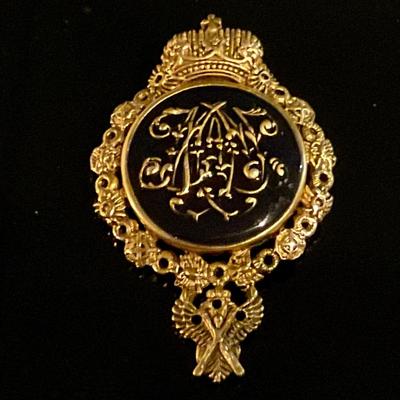 Black and gold pin/ broach with floral motif