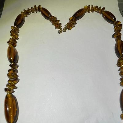 Vintage Mid-Century Amber Color Resin/Lucite Necklace 30" Long in Good Preowned Condition.