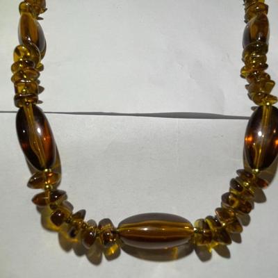Vintage Mid-Century Amber Color Resin/Lucite Necklace 30" Long in Good Preowned Condition.