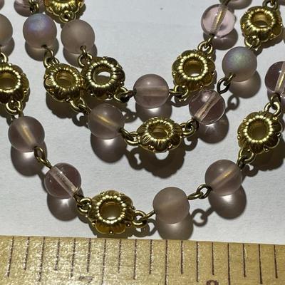 Vintage Preowned Gold-tone Triple Strand Pinkish Glass Bead Fashion Necklace 16-19" Adjustable in Very Good Preowned Condition.