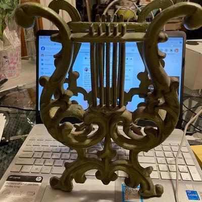 Vintage Mid-Century Modern 11" Tall Cast Iron Magazine Rack in Good Preowned Condition.