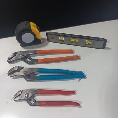 Assortment of piers - Rigid pipe wrench - tape measure and small level